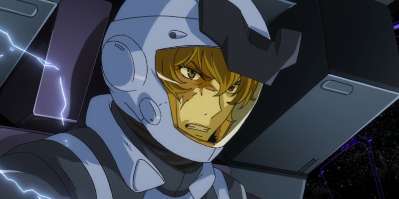 Graham Aker angrily looking around in his mobile suit