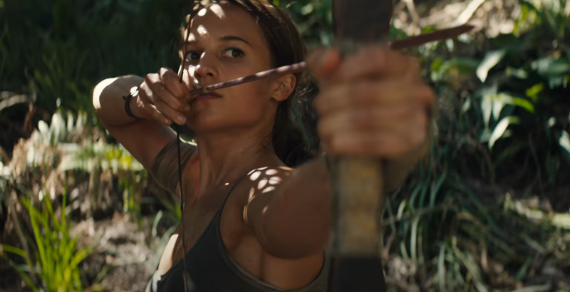 Lara Croft shooting a bow and arrow in the jungle