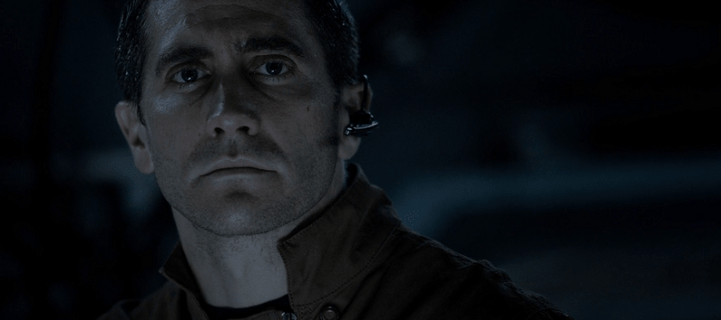 Jake Gyllenhaal looking serious with an ear piece in Life