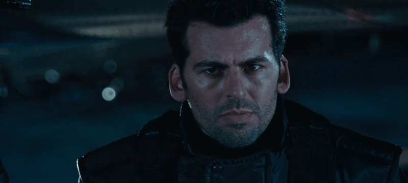 Oded Fehr looking serious in the darkness