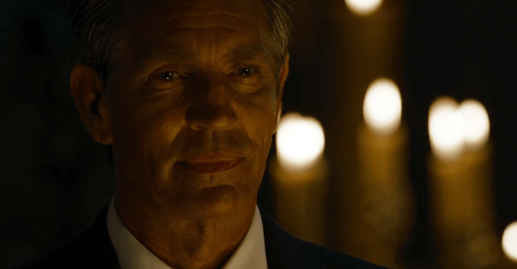 Eric Roberts standing near candles