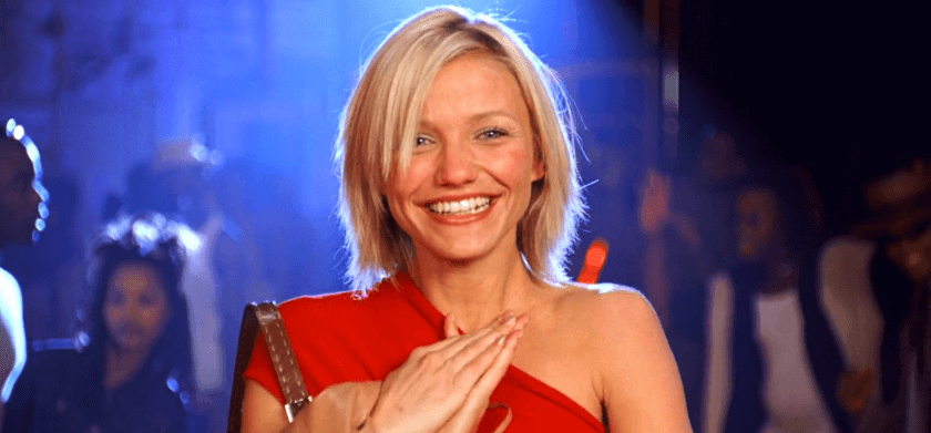 Cameron Diaz smiling in a red dress at a party