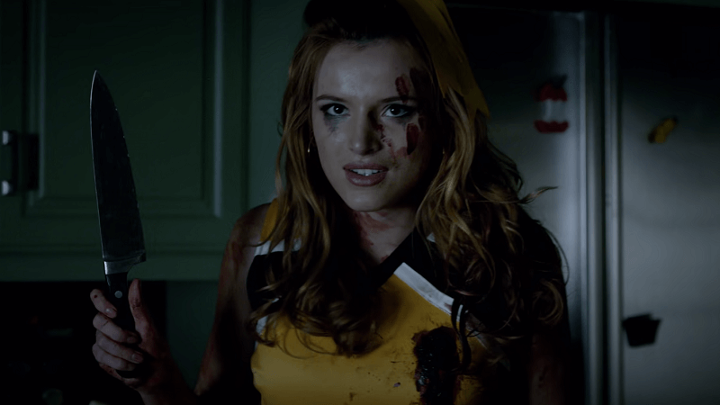 Bella Thorne as Allison holding a kitchen knife while being covered in blood.