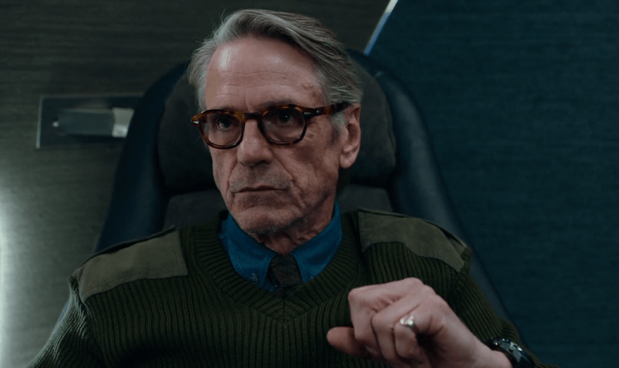 Alfred in the Justice League movie wearing glasses and clinching fist.