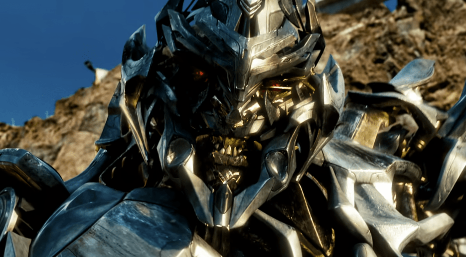 Megatron with sharp teeth and scary metallic design near a mountain in Transformers.