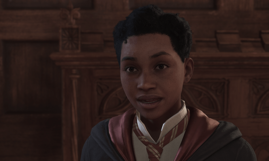 Natsai Onai speaking with a friendly expression in her Gryffindor robes in Hogwarts.