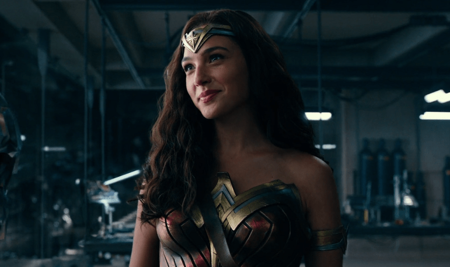 Gal Gadot as Wonder Woman smiling warmly with her warrior Amazon outfit in Batman's lair.
