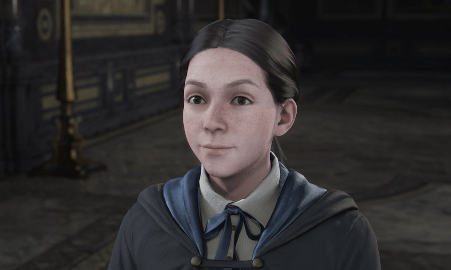 Zenobia Noke with pale skin and freckles looking excited in Ravenclaw robes inside of Hogwarts.