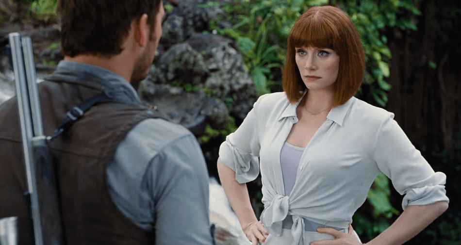 Bryce Dallas Howard as Claire with hands on hips looking angrily at Chris Pratt's Owen.