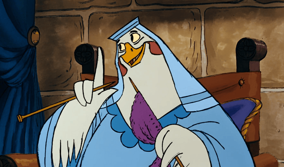 Lady Kluck pointing her finger while knitting with a warm smile on her face.